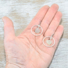 Load image into Gallery viewer, Pale green sea glass earrings encircled by textured hoops of sterling silver. (E586)
