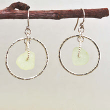 Load image into Gallery viewer, Pale green sea glass earrings encircled by textured hoops of sterling silver. (E586)
