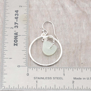 Pale green sea glass earrings encircled by textured hoops of sterling silver. (E586)