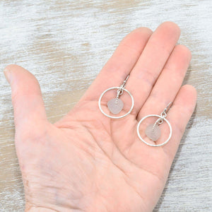 Pale lavender sea glass earrings encircled by textured hoops of sterling silver. (E587)