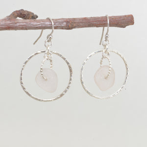 Pale lavender sea glass earrings encircled by textured hoops of sterling silver. (E587)