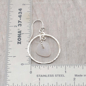 Pale lavender sea glass earrings encircled by textured hoops of sterling silver. (E587)