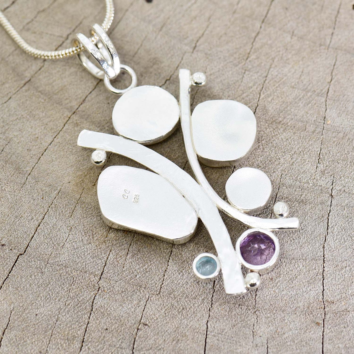 Sea glass statement pendant necklace in a hand crafted setting of tarnish resistant sterling silver accented with semi-precious gemstones. (N608)