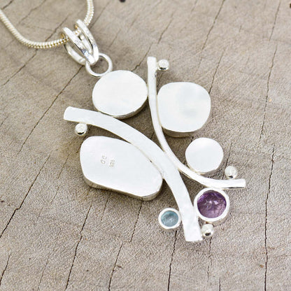 Sea glass statement pendant necklace in a hand crafted setting of tarnish resistant sterling silver accented with semi-precious gemstones. (N608)