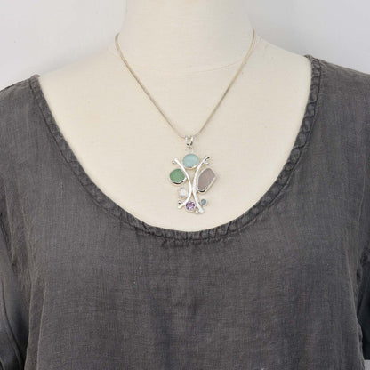 Sea glass statement pendant necklace in a hand crafted setting of tarnish resistant sterling silver accented with semi-precious gemstones. (N608)