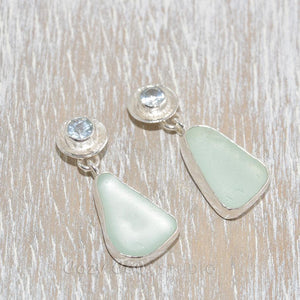 Sea glass earrings in hand crafted sterling silver settings accented with semi-precious gemstones of pale blue topaz