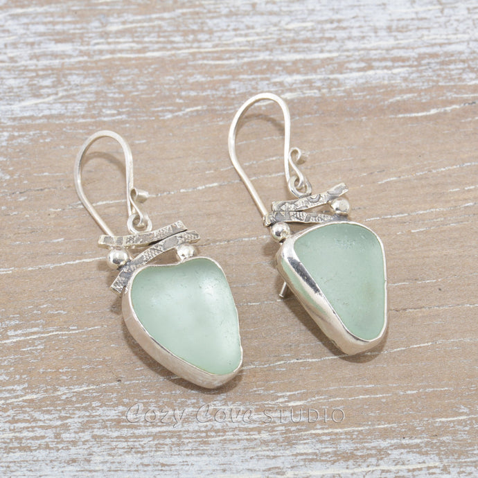 Sea glass earrings in hand crafted sterling silver settings.