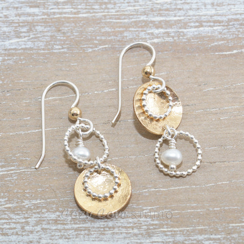 Asymetric dangle earrings in sterling silver and 14K gold fill with cultured pearl dangles.