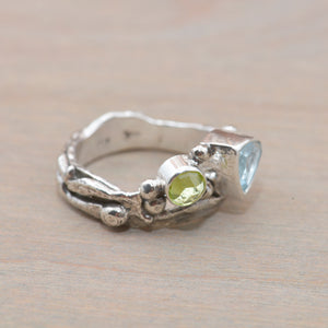 Organic topaz and peridot ring in a hand crafted setting of sterling silver. (R706)