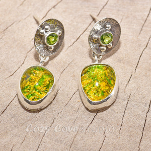 Fiery dichroic fused glass earrings in  hand crafted sterling silver settings accented with a peridot. (E710)