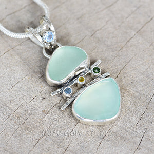 Sea glass and chalcedony pendant necklace in a hand crafted sterling silver setting accented with sparkly cubic zirconias. (N730)