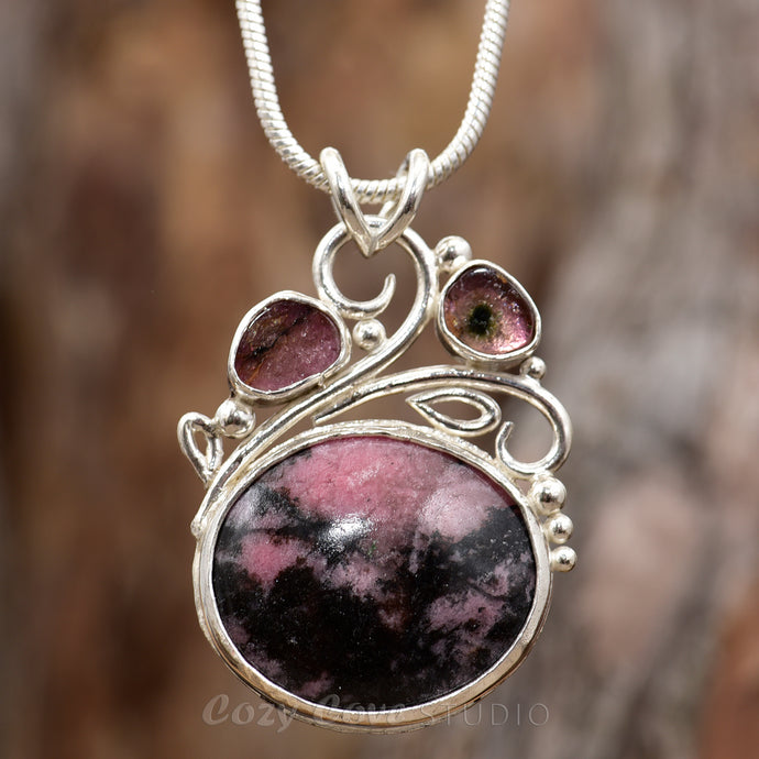 Gemstone necklace with a pink and gray rhodochrosite cabochon and bicolor tourmaline slices in an handcrafted setting of sterling silver. (N737)