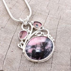 Gemstone necklace with a pink and gray rhodochrosite cabochon and bicolor tourmaline slices in an handcrafted setting of sterling silver. (N737)