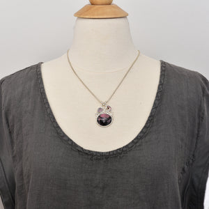 Gemstone necklace with a pink and gray rhodochrosite cabochon and bicolor tourmaline slices in an handcrafted setting of sterling silver. (N737)