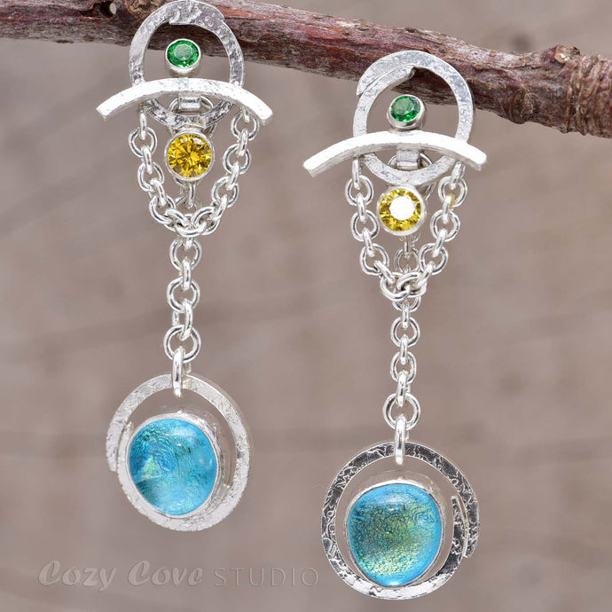 Transformation earrings with dichroic glass cabochons accented with sparkly cubic zirconias in sterling silver. (e739)