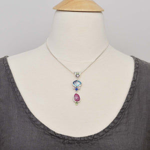Dichroic glass pendant necklace in shades of blue and pink accented with semi-precious lapis lazuli and sparkly cubic zirconias. (N749)
