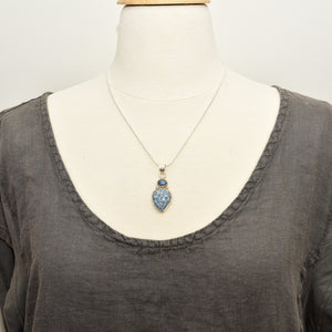 Pendant necklace with hand made enamel cabochon in shades of blue in a setting of sterling silver. (N764)