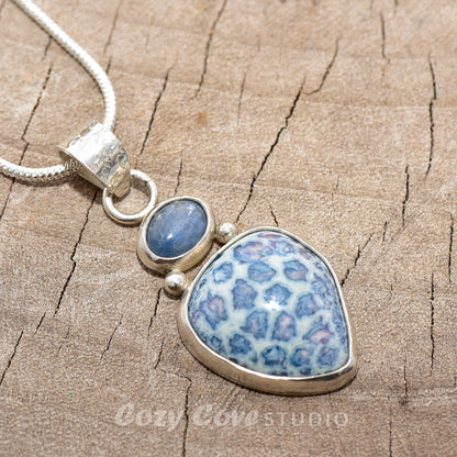 Pendant necklace with hand made enamel cabochon in shades of blue in a setting of sterling silver. (N764)