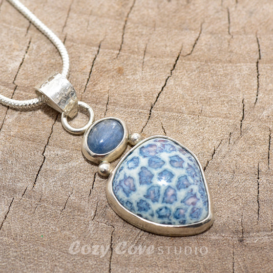 Pendant necklace with hand made enamel cabochon in shades of blue in a setting of sterling silver. (N764)