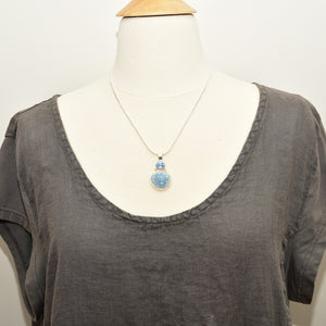 Pendant necklace with hand made enamel cabochon in blue over pale yellow in a hand crafted setting of sterling silver. (N765)