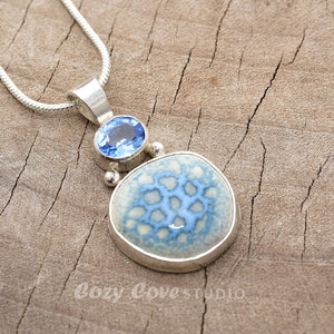 Pendant necklace with hand made enamel cabochon in blue over pale yellow in a hand crafted setting of sterling silver. (N765)