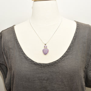 Pendant necklace with handmade enamel cabochon in pale pink and purple  in a hand crafted setting of sterling silver. (N767)