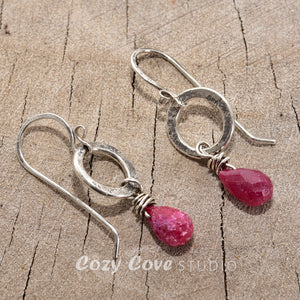 Earrings of hand wire wrapped ruby briolettes dangle from circles of hand forged sterling silver (E779)