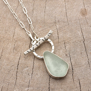 Pale green sea glass necklace in a hand crafted setting of sterling silver. (N787)