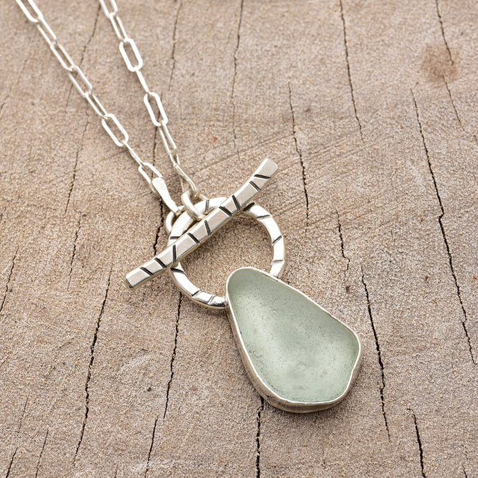 Pale green sea glass necklace in a hand crafted setting of sterling silver. (N787)