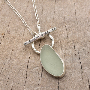 Pale green sea glass necklace in a hand crafted setting of sterling silver. (N788)