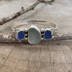 Sea glass cuff bracelet with seafoam green sea glass flanked by cornflower blue in a handcrafted setting of sterling silver. (B791)