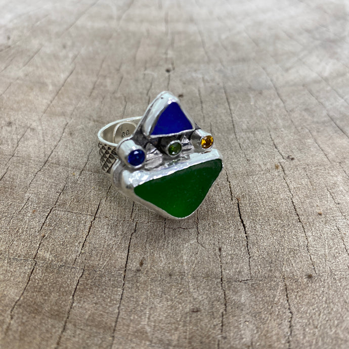 Dramatic sea glass ring with cobalt blue and kelly green sea glass accented with sparkly cubic zirconias in a handcrafted setting of sterling silver. (R800)
