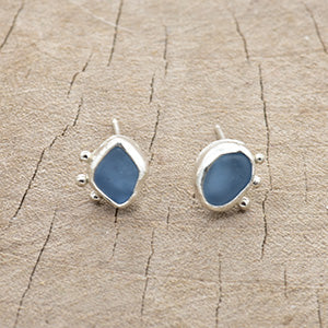 Sea glass earrings of cornflower blue in hand crafted bezel settings of sterling silver. (E805)
