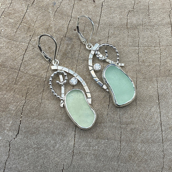 Sea glass earrings in hand crafted settings of sterling silver accented with sparkly cubic zirconias. (E824)
