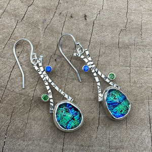 Flashy blue/green dichroic glass earrings in hand crafted settings of sterling silver. (E829)