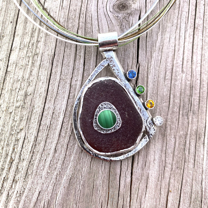 Sea glass pendant necklace in a hand crafted setting of sterling silver accented with sparkly CZs. (N574)